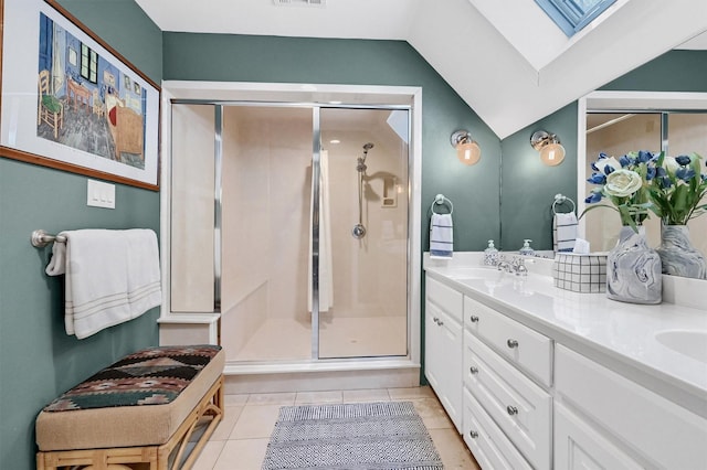 full bath with tile patterned flooring, double vanity, a sink, and a stall shower