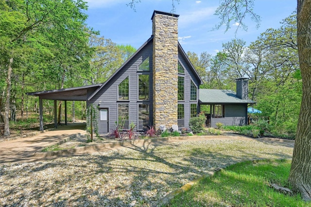view of home's exterior featuring a carport and a chimney