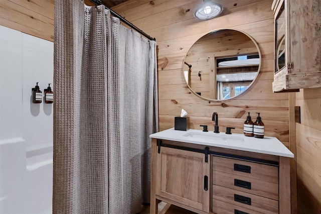 bathroom featuring wooden walls, vanity, and a shower with curtain