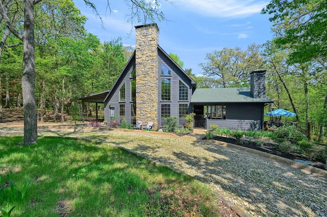 back of property with a chimney