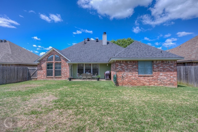 5310 Lucerne Ln, Bossier City, LA 71112 - back of house with a fenced backyard, a lawn, roof with shingles, a patio area, and brick siding