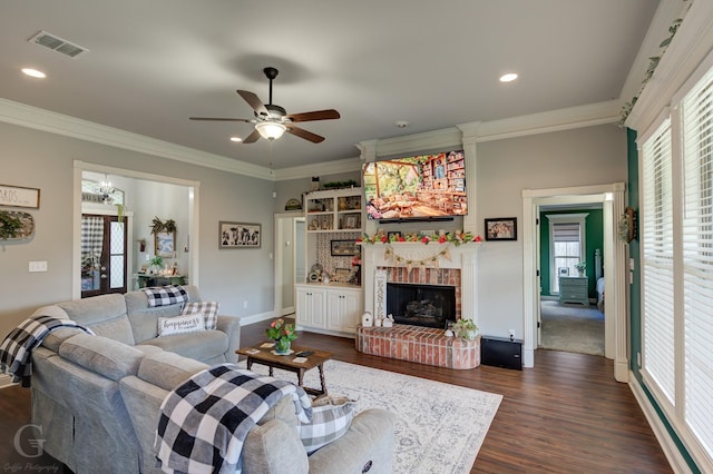 5310 Lucerne Ln, Bossier City, LA 71112 - living room with visible vents, a brick fireplace, dark wood-style flooring, ornamental molding, and a ceiling fan
