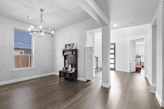 dining space with an inviting chandelier, baseboards, dark wood-style floors, and visible vents