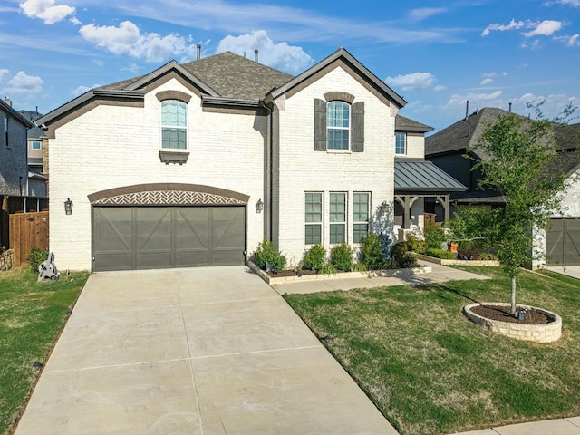 french provincial home featuring fence, a front lawn, brick siding, a garage, and driveway