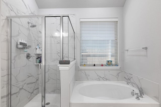 full bath with a marble finish shower and a bath