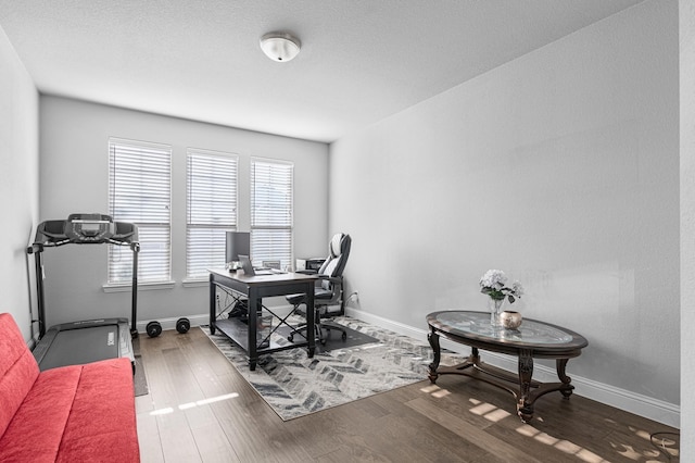 office area featuring baseboards and dark wood finished floors