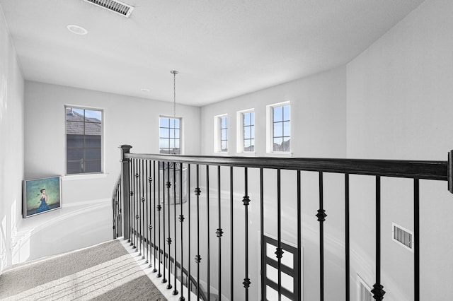 hall featuring visible vents