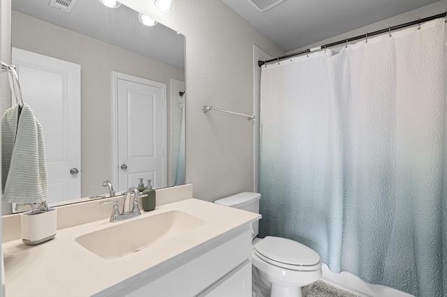 full bath with toilet, visible vents, and vanity
