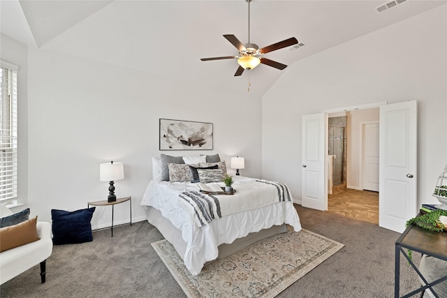 carpeted bedroom with baseboards, visible vents, a ceiling fan, and high vaulted ceiling