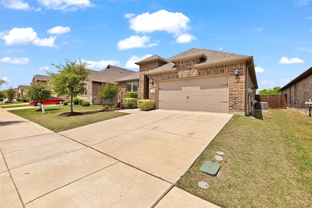 view of front of property featuring fence, concrete driveway, an attached garage, brick siding, and a front yard