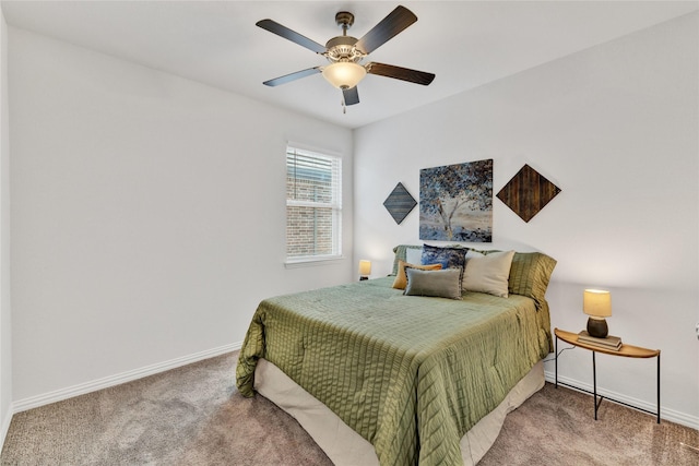 carpeted bedroom with ceiling fan and baseboards