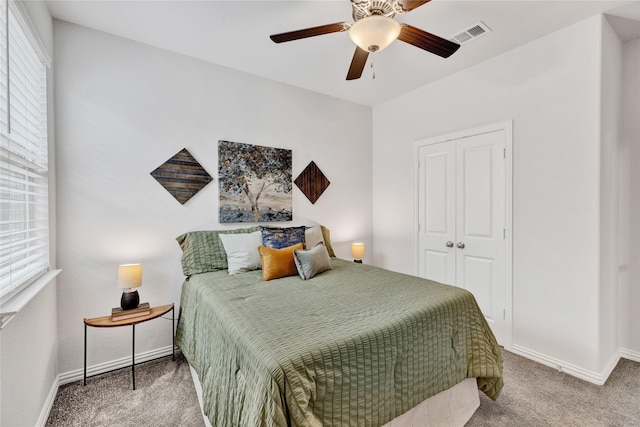 bedroom with visible vents, baseboards, carpet floors, and multiple windows