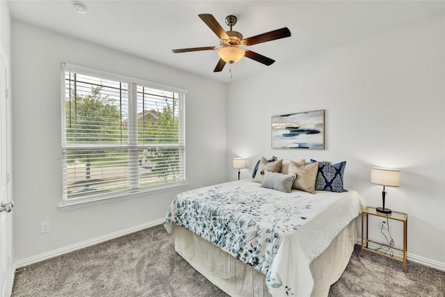 carpeted bedroom featuring baseboards and ceiling fan