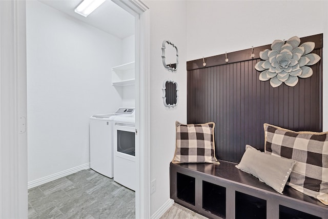 mudroom with independent washer and dryer and baseboards
