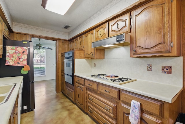 112 Charles St, Desoto, TX 75115 - kitchen featuring stainless steel appliances, a sink, visible vents, brown cabinetry, and under cabinet range hood