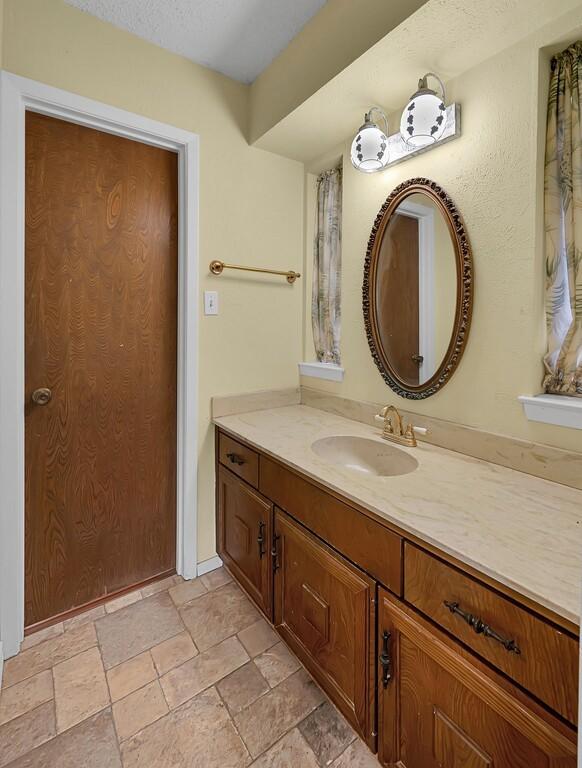 bathroom with vanity and stone tile flooring