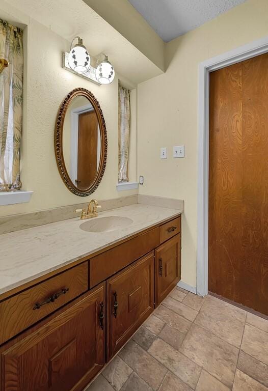 bathroom featuring vanity and stone tile flooring