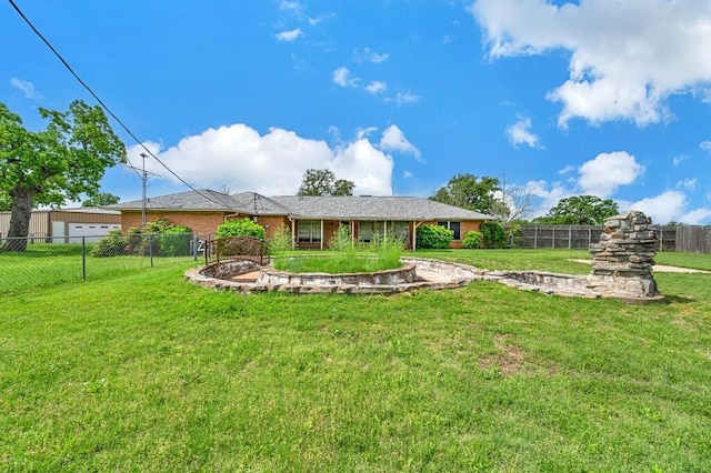 rear view of house with a yard and a fenced backyard