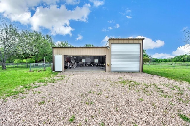 detached garage featuring fence