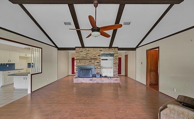 unfurnished living room with light wood-style floors, visible vents, a ceiling fan, and beam ceiling