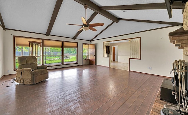 unfurnished living room featuring vaulted ceiling with beams, wood finished floors, baseboards, and a ceiling fan