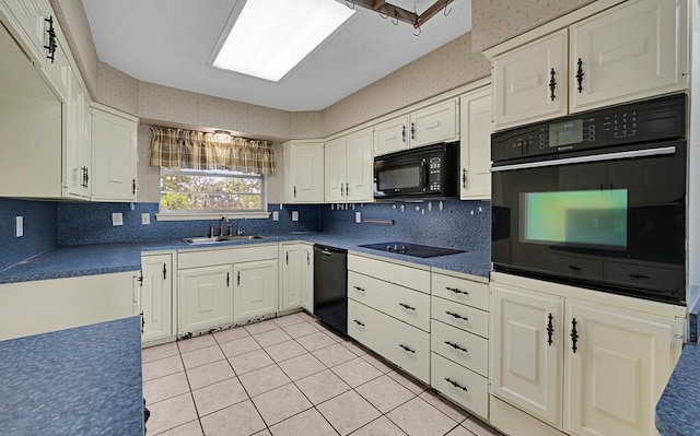 kitchen with a sink, black appliances, white cabinetry, backsplash, and light tile patterned flooring