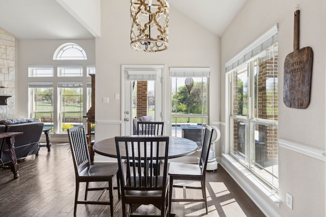 619 Southwestern Dr, Rockwall, TX 75087 - dining space with dark wood finished floors, a chandelier, and high vaulted ceiling