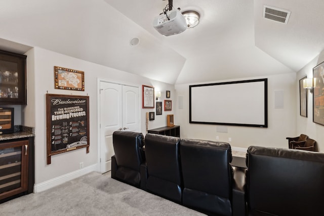 619 Southwestern Dr, Rockwall, TX 75087 - cinema room featuring beverage cooler, vaulted ceiling, light colored carpet, and a bar