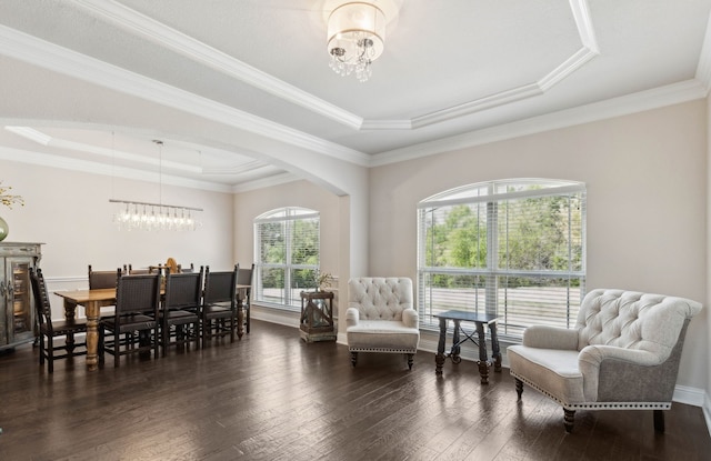 619 Southwestern Dr, Rockwall, TX 75087 - living area with a chandelier, a tray ceiling, dark wood-style flooring, arched walkways, and ornamental molding