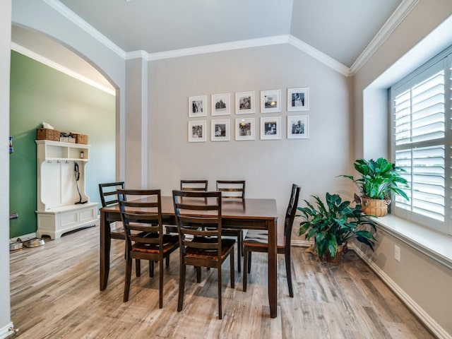 175 Balfour Dr, Fate, TX 75189 - dining area with light wood-style flooring, crown molding, arched walkways, and vaulted ceiling