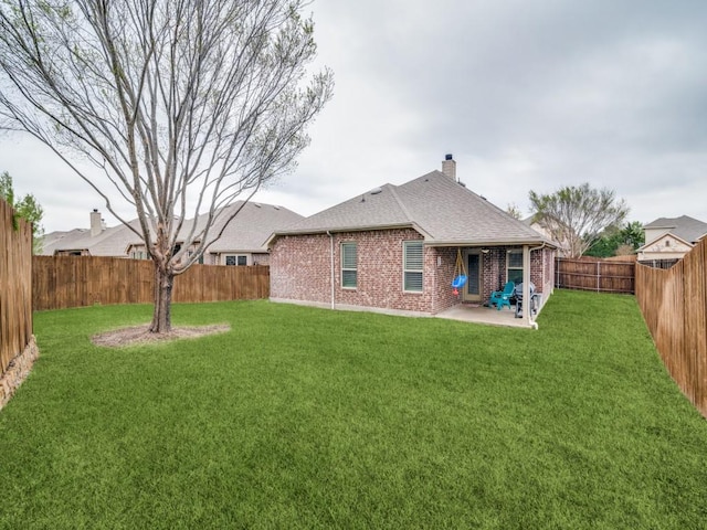 175 Balfour Dr, Fate, TX 75189 - back of house with brick siding, a patio area, a chimney, a fenced backyard, and a shingled roof