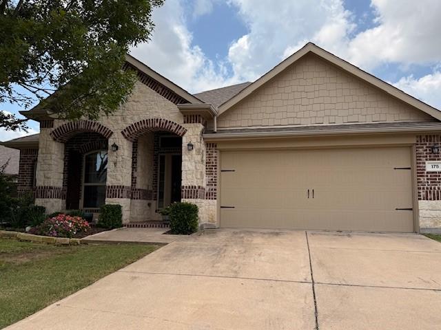 175 Balfour Dr, Fate, TX 75189 - view of front of property featuring stone siding, driveway, a garage, and brick siding