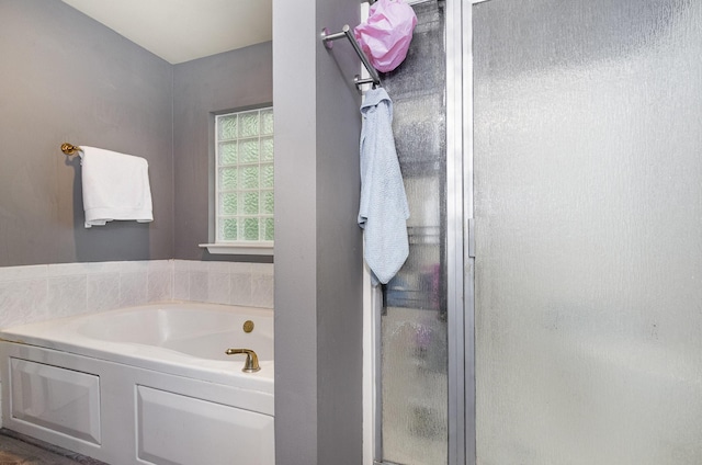 full bath with a garden tub and a stall shower