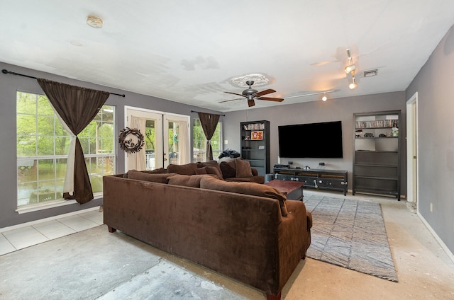 living area with french doors, visible vents, ceiling fan, and a healthy amount of sunlight