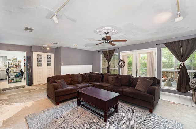 living room featuring french doors, ceiling fan, rail lighting, and visible vents
