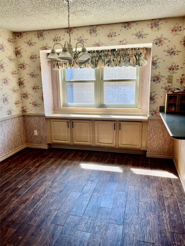 2124 Parkhaven Dr, Plano, TX 75075 - unfurnished dining area featuring dark wood-style floors, a textured ceiling, wainscoting, and wallpapered walls