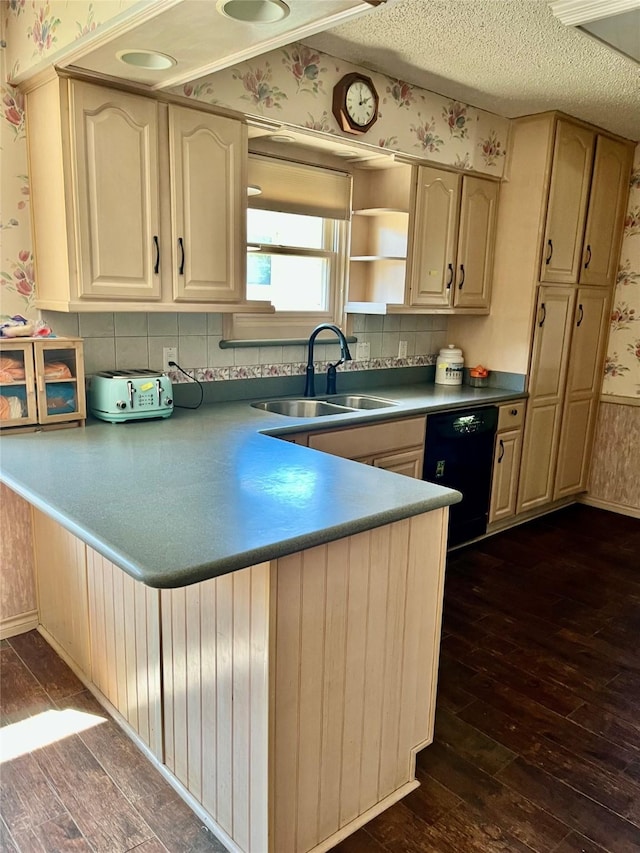 2124 Parkhaven Dr, Plano, TX 75075 - kitchen with a textured ceiling, dishwasher, a sink, wallpapered walls, and dark wood-style floors