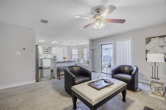 3144 Longbow Dr, Grand Prairie, TX 75052 - living area with light colored carpet, baseboards, visible vents, and a ceiling fan
