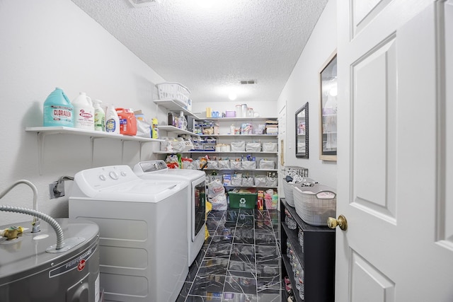3144 Longbow Dr, Grand Prairie, TX 75052 - washroom with washer and clothes dryer, a textured ceiling, visible vents, marble finish floor, and electric water heater