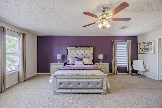 3144 Longbow Dr, Grand Prairie, TX 75052 - carpeted bedroom featuring visible vents, a textured ceiling, ceiling fan, and baseboards