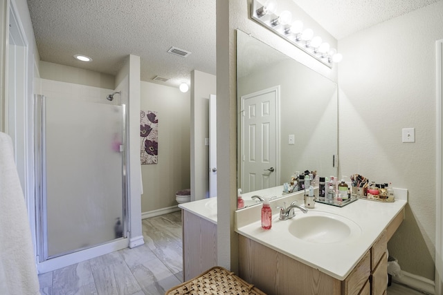 3144 Longbow Dr, Grand Prairie, TX 75052 - full bathroom featuring vanity, a textured ceiling, visible vents, and a stall shower