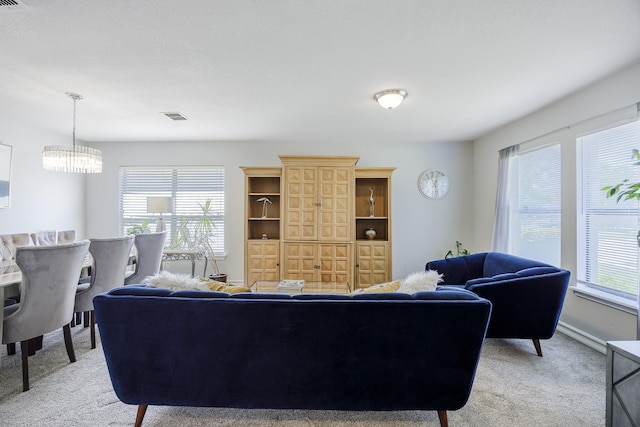3144 Longbow Dr, Grand Prairie, TX 75052 - living room featuring light carpet, a notable chandelier, and visible vents
