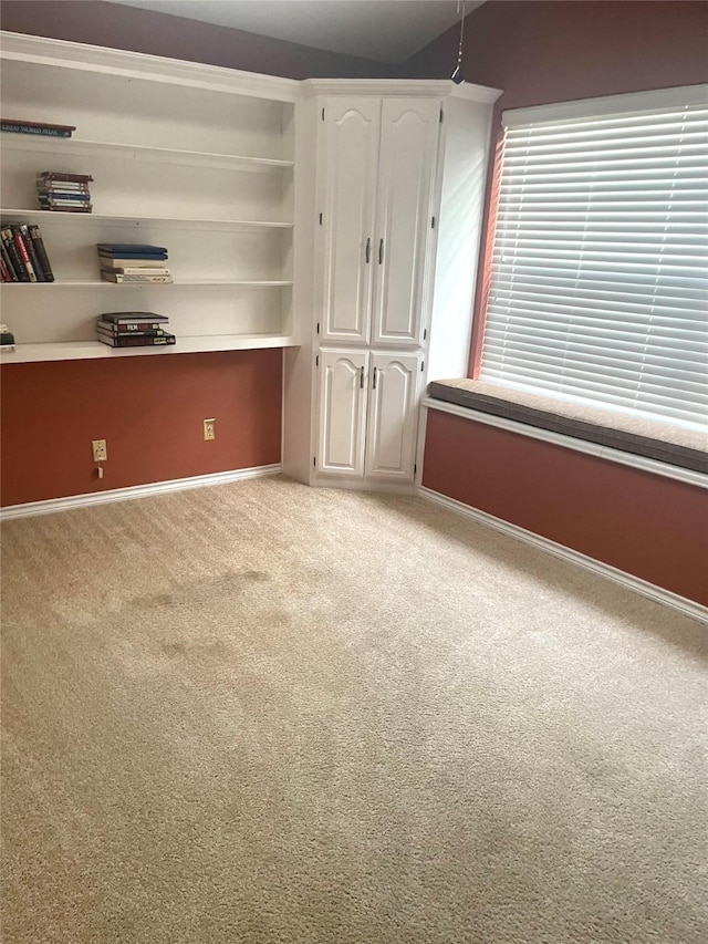 unfurnished bedroom featuring baseboards and carpet flooring