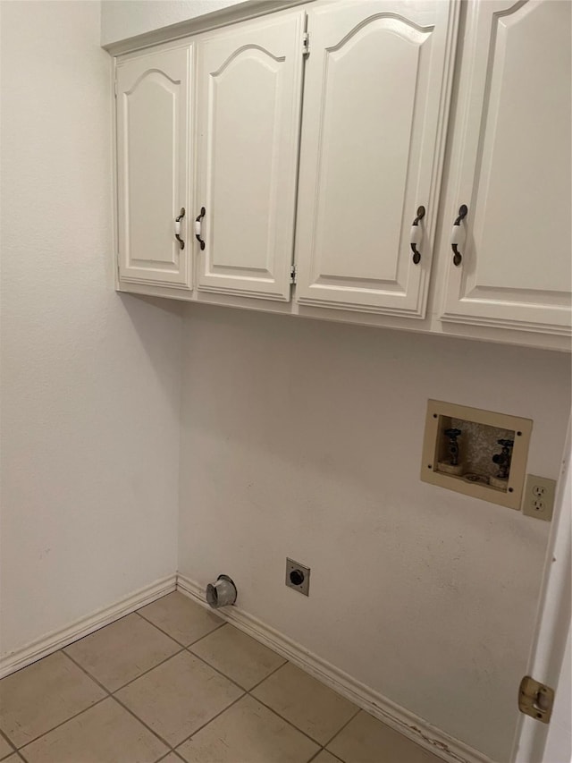laundry room with tile patterned flooring, baseboards, hookup for an electric dryer, cabinet space, and washer hookup