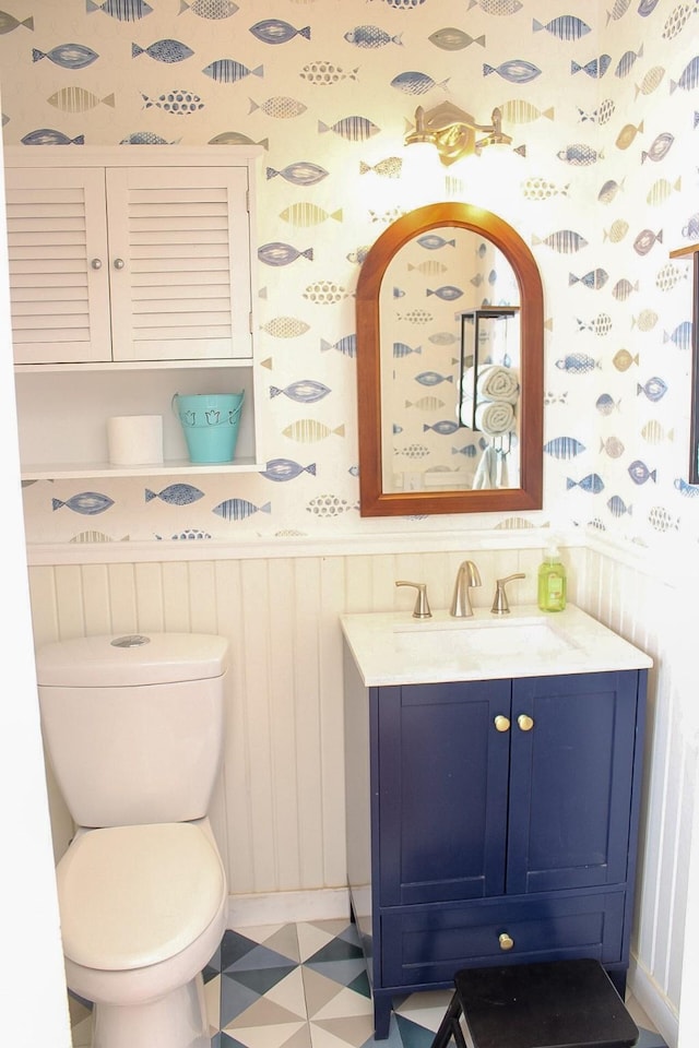 7650 Shade Tree Ln, Celina, TX 75009 - bathroom featuring wallpapered walls, vanity, a wainscoted wall, toilet, and tile patterned floors