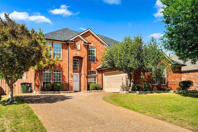 5921 Colby Dr, Plano, TX 75094 - traditional-style home featuring a front yard, fence, concrete driveway, brick siding, and roof with shingles
