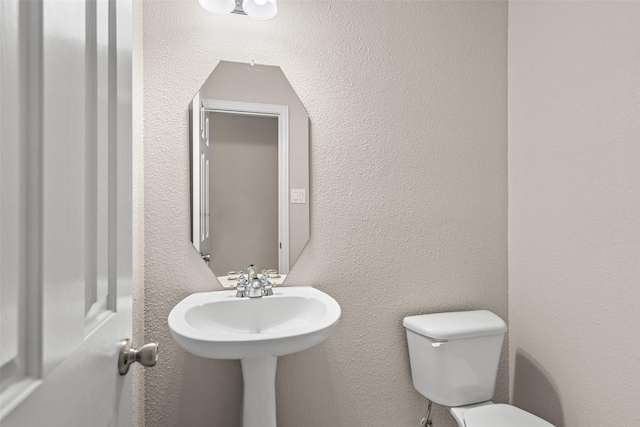 5921 Colby Dr, Plano, TX 75094 - half bathroom with toilet and a textured wall