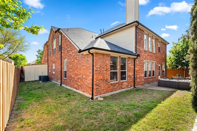 5921 Colby Dr, Plano, TX 75094 - rear view of property featuring central AC unit, a fenced backyard, a patio, and a lawn