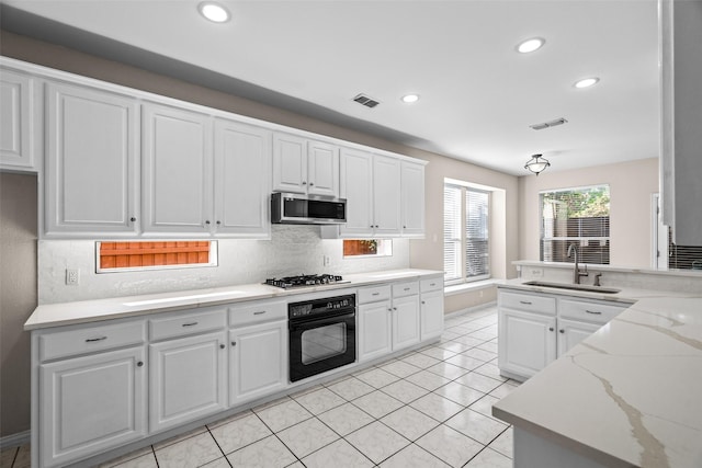 5921 Colby Dr, Plano, TX 75094 - kitchen featuring a sink, visible vents, appliances with stainless steel finishes, and white cabinetry