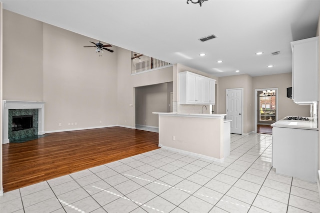 5921 Colby Dr, Plano, TX 75094 - kitchen with open floor plan, light tile patterned floors, light countertops, visible vents, and ceiling fan